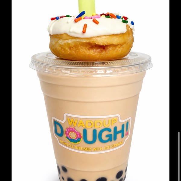 Waddup Dough! coffee boba shake topped with a frosted donut and sprinkles, with a green straw.